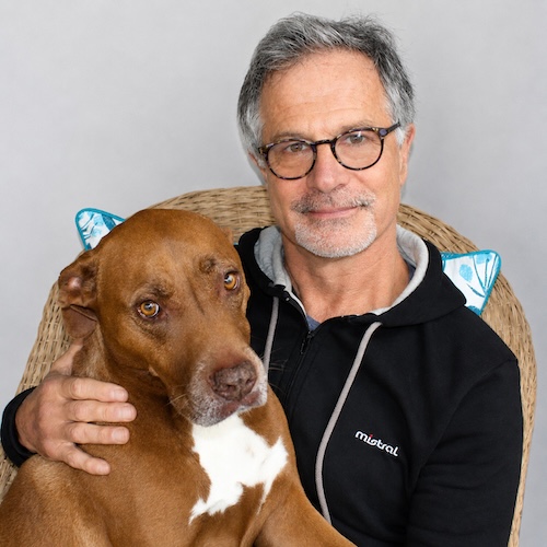 Portrait of Dr Hernan Azorin with a dog, board member at AfriPaw.