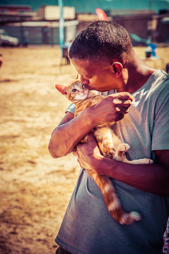 Man holding a cat during an AfriPaw community programme.