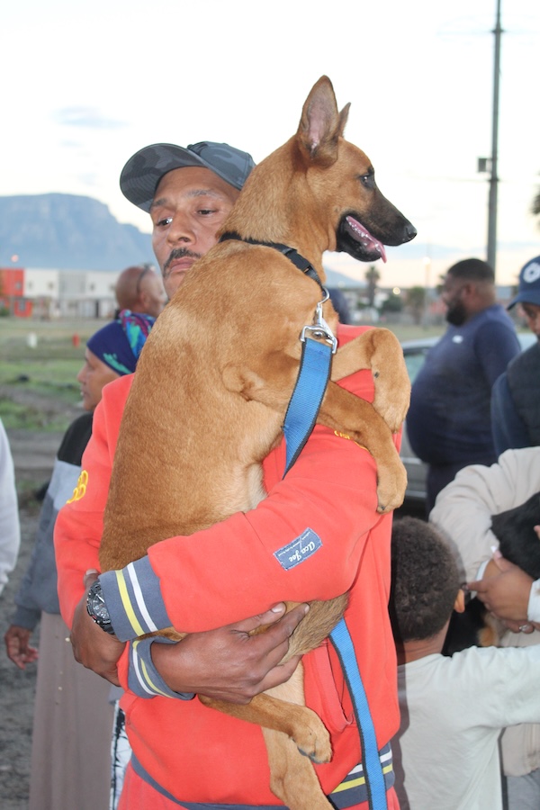 Community member embracing his dog during an AfriPaw programme.