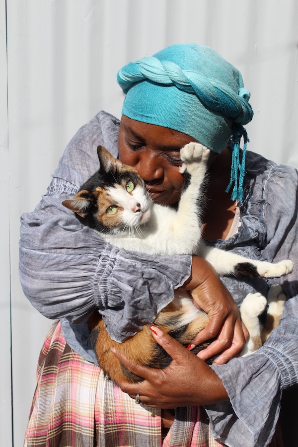 Woman cuddling a cat during an AfriPaw animal welfare programme.