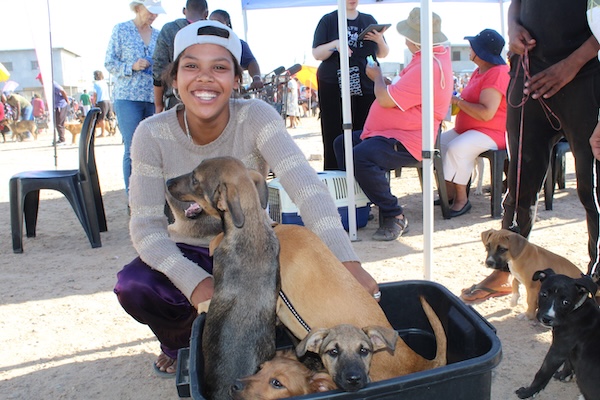 Community member with her dogs at an AfriPaw Pet Clinic event.