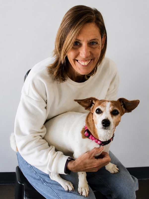Portrait of Kathleen Shuttleworth with a dog, Programme Co-ordinator at AfriPaw.